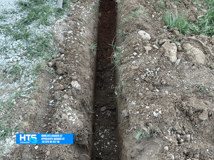 Ausgehobene Künette im Privatgarten nach Erdarbeiten für die Verlegung von Leitungen und Hausanschlüssen durch HTS Erdbewegung.